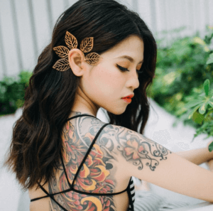 an asian lady with a tattoo